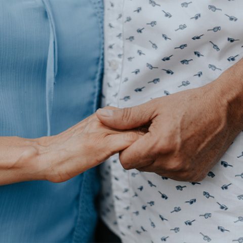 holding person's hand during parkinson's assessment